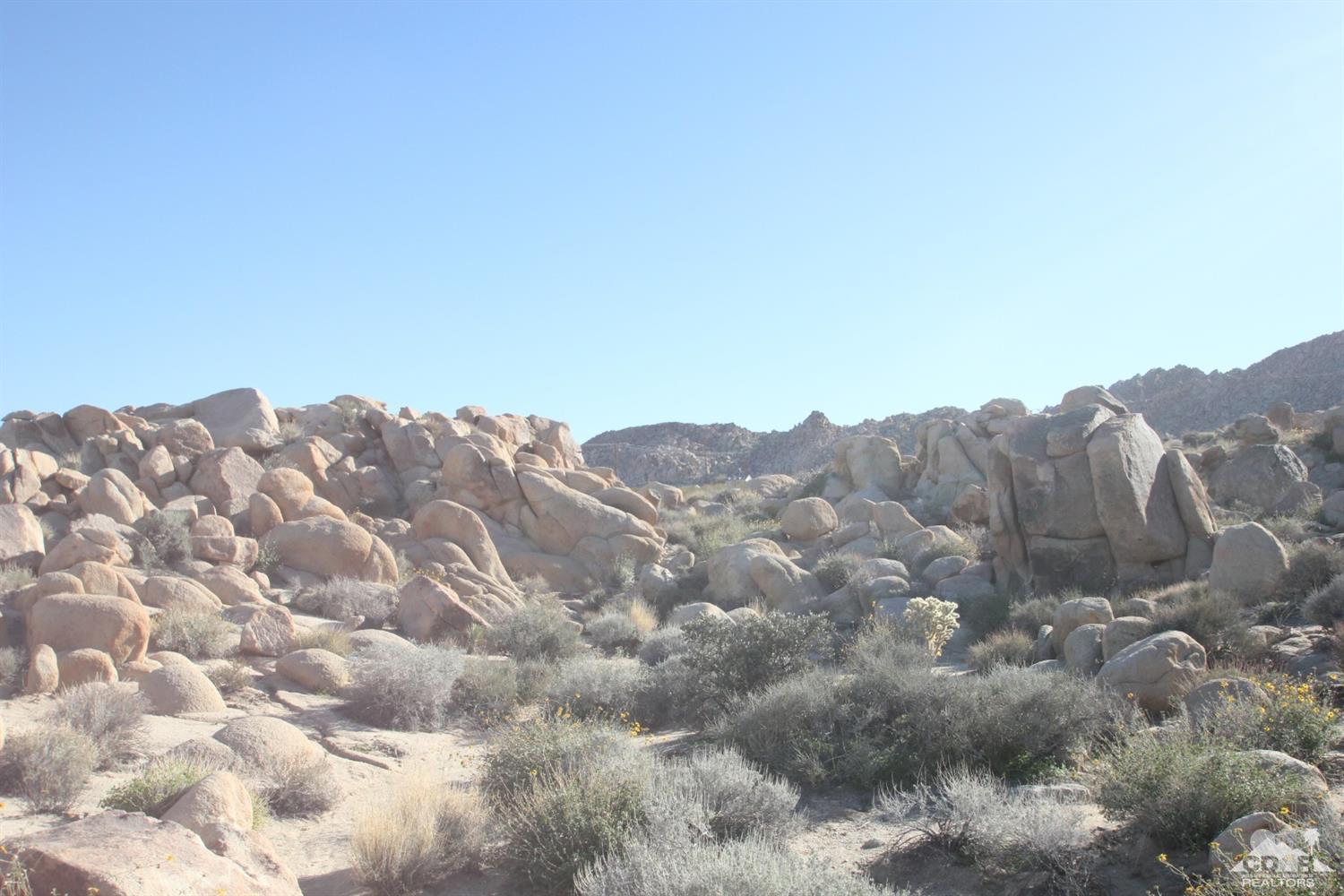 63177 Chickasaw Road Joshua Tree, CA 92252 - Photo 7 of 8 a view of a large building with mountains in the background