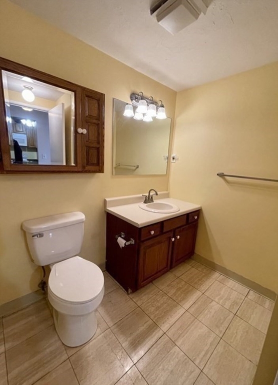 100 Cove Way, Unit 608 Quincy, MA 02169 - Photo 15 of 20 a bathroom with a sink mirror vanity and toilet