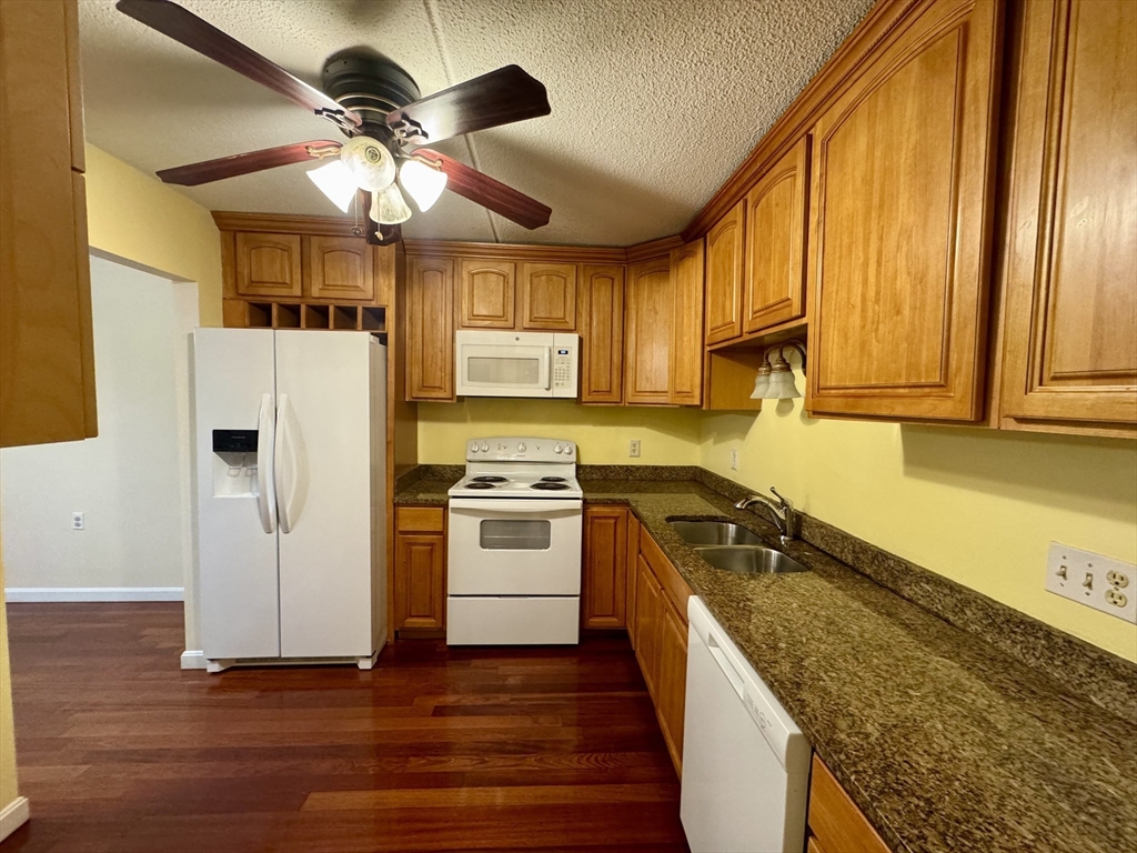 100 Cove Way, Unit 608 Quincy, MA 02169 - Photo 4 of 20 a kitchen with granite countertop a sink stainless steel appliances and cabinets