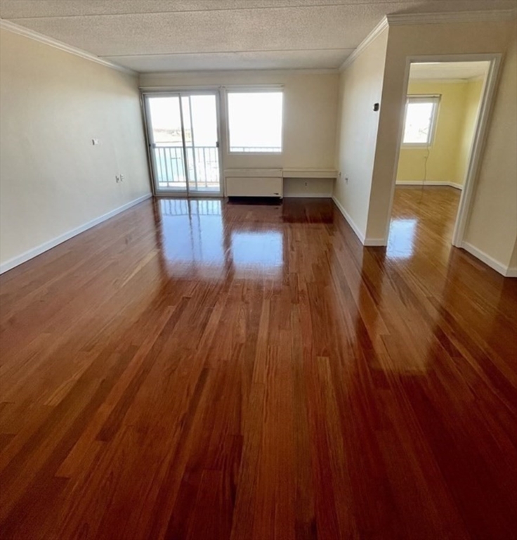 100 Cove Way, Unit 608 Quincy, MA 02169 - Photo 7 of 20 wooden floor in an empty room with a window
