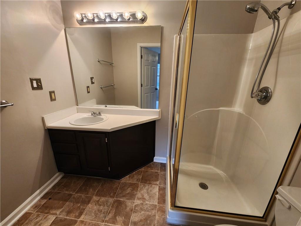 1411 Keys Crossing Drive Northeast Brookhaven, GA 30319 - Photo 12 of 24 a bathroom with a sink a mirror and shower