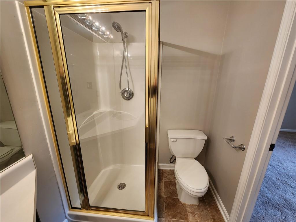 1411 Keys Crossing Drive Northeast Brookhaven, GA 30319 - Photo 13 of 24 a bathroom with a toilet and a shower