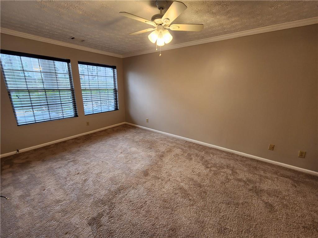 1411 Keys Crossing Drive Northeast Brookhaven, GA 30319 - Photo 14 of 24 an empty room with windows and fan