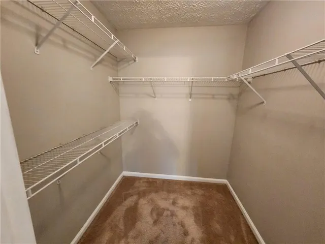 a white toilet sitting next to a bath tub