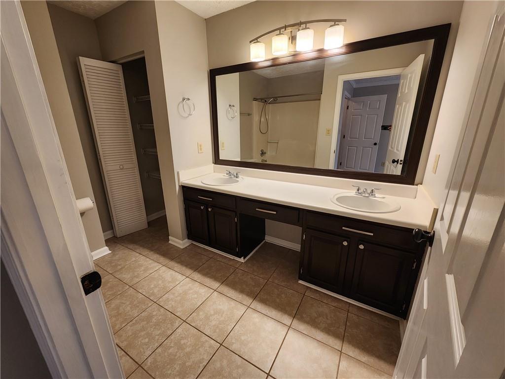 1411 Keys Crossing Drive Northeast Brookhaven, GA 30319 - Photo 16 of 24 a bathroom with a double vanity sink and mirror