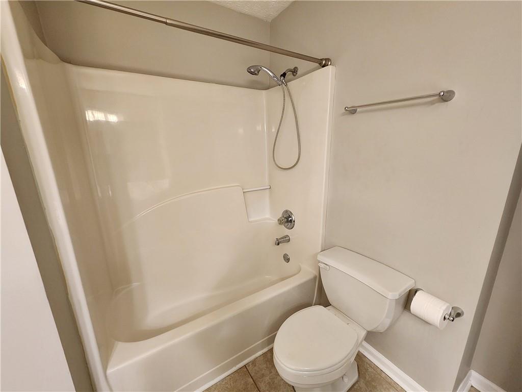 1411 Keys Crossing Drive Northeast Brookhaven, GA 30319 - Photo 17 of 24 a white toilet sitting next to a bath tub