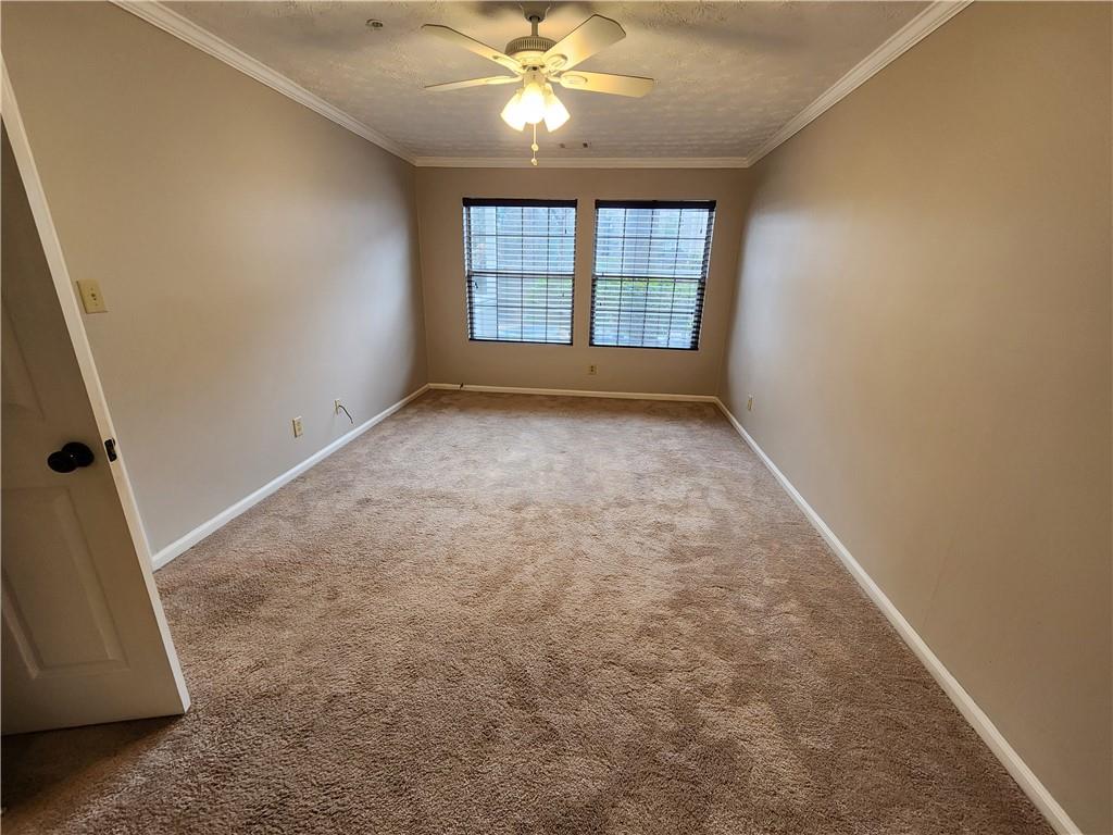 1411 Keys Crossing Drive Northeast Brookhaven, GA 30319 - Photo 19 of 24 an empty room with windows and fan