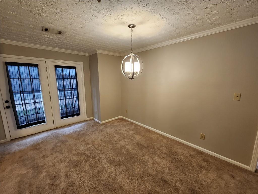 1411 Keys Crossing Drive Northeast Brookhaven, GA 30319 - Photo 8 of 24 a view of an empty room with a window and a chandelier fan