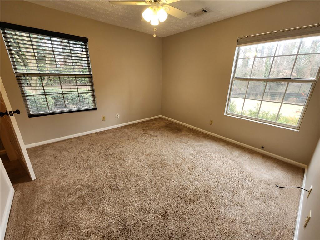 1411 Keys Crossing Drive Northeast Brookhaven, GA 30319 - Photo 10 of 24 an empty room with windows and chandelier fan