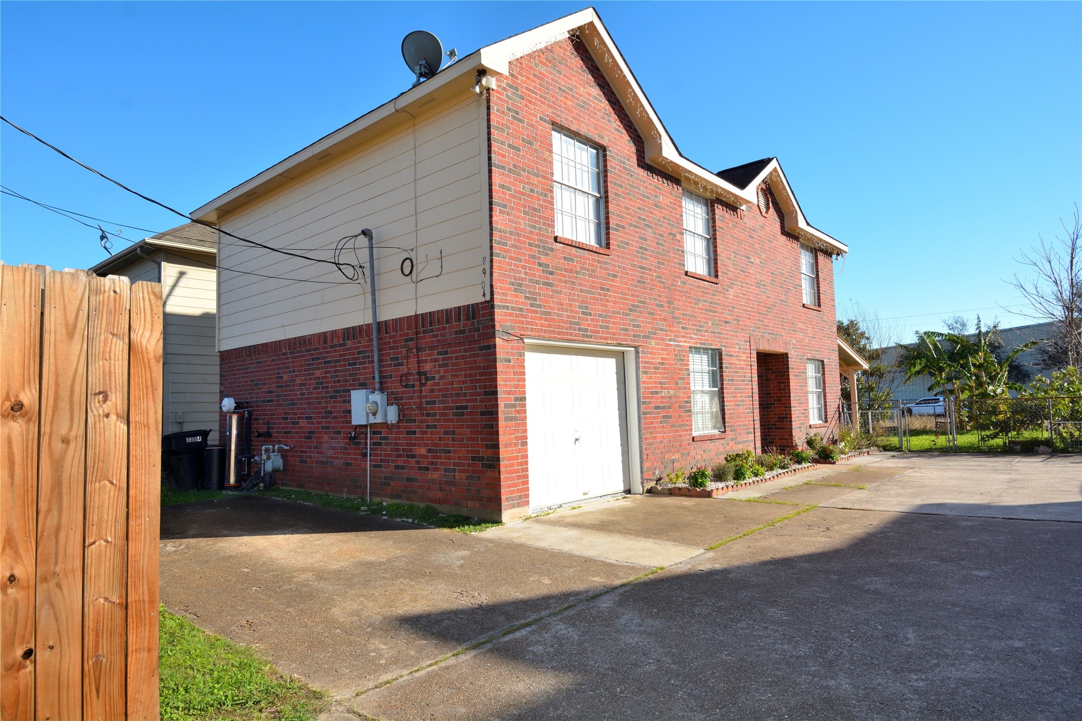 8904 Ledge Street Houston, TX 77075 - Photo 1 of 20 a front view of a house with a yard and garage