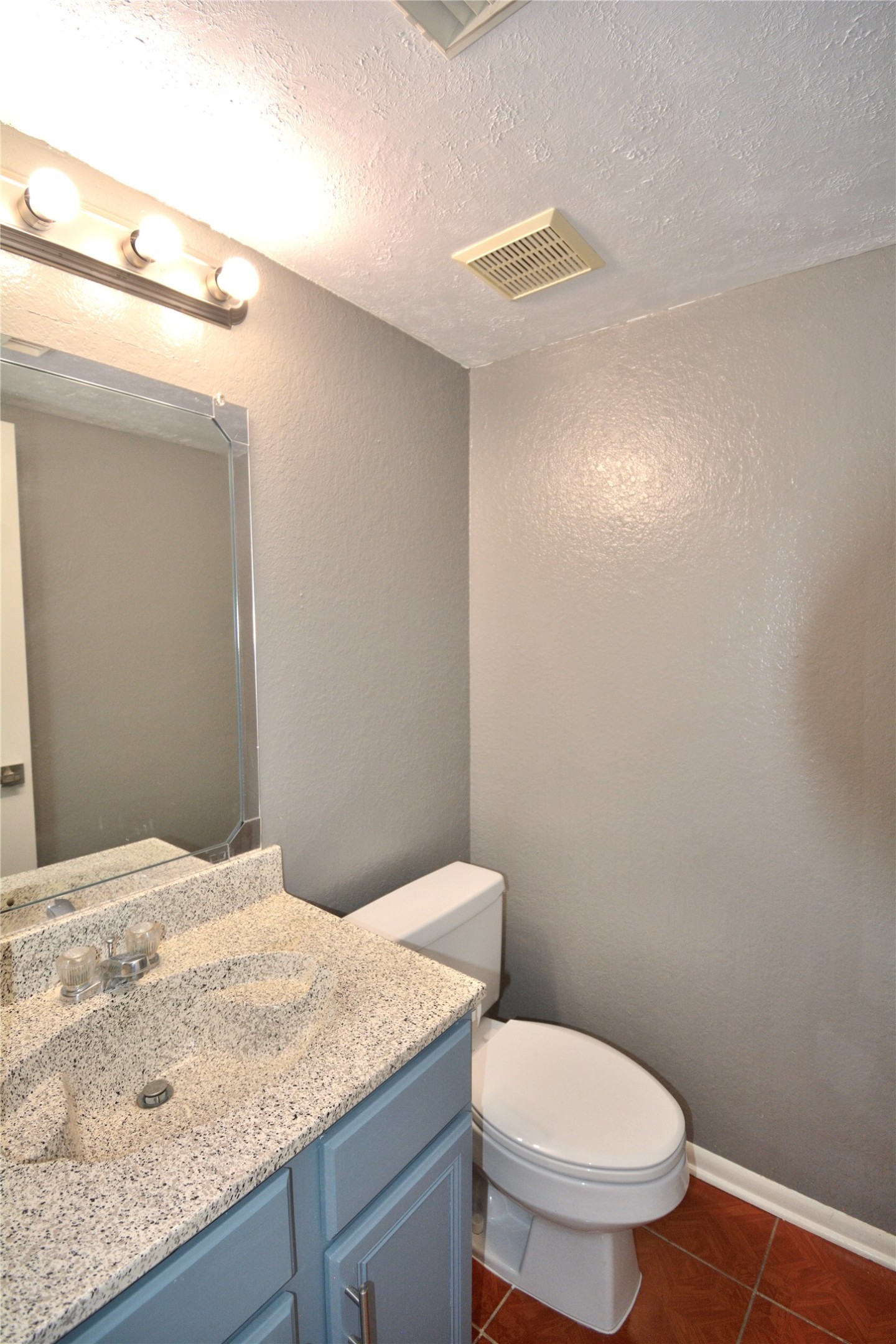 8904 Ledge Street Houston, TX 77075 - Photo 11 of 20 a bathroom with a granite countertop toilet and a sink