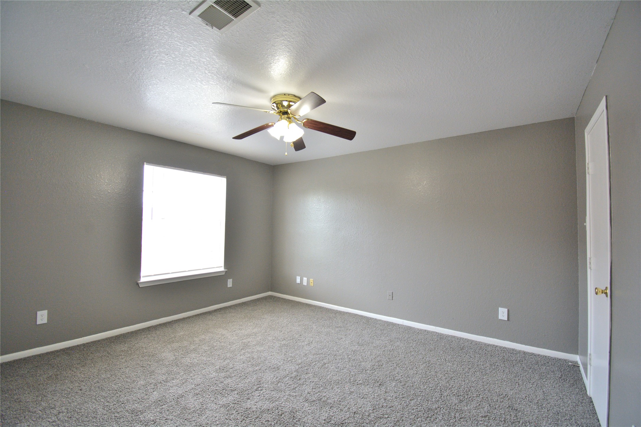 8904 Ledge Street Houston, TX 77075 - Photo 13 of 20 an empty room with a window and a ceiling fan