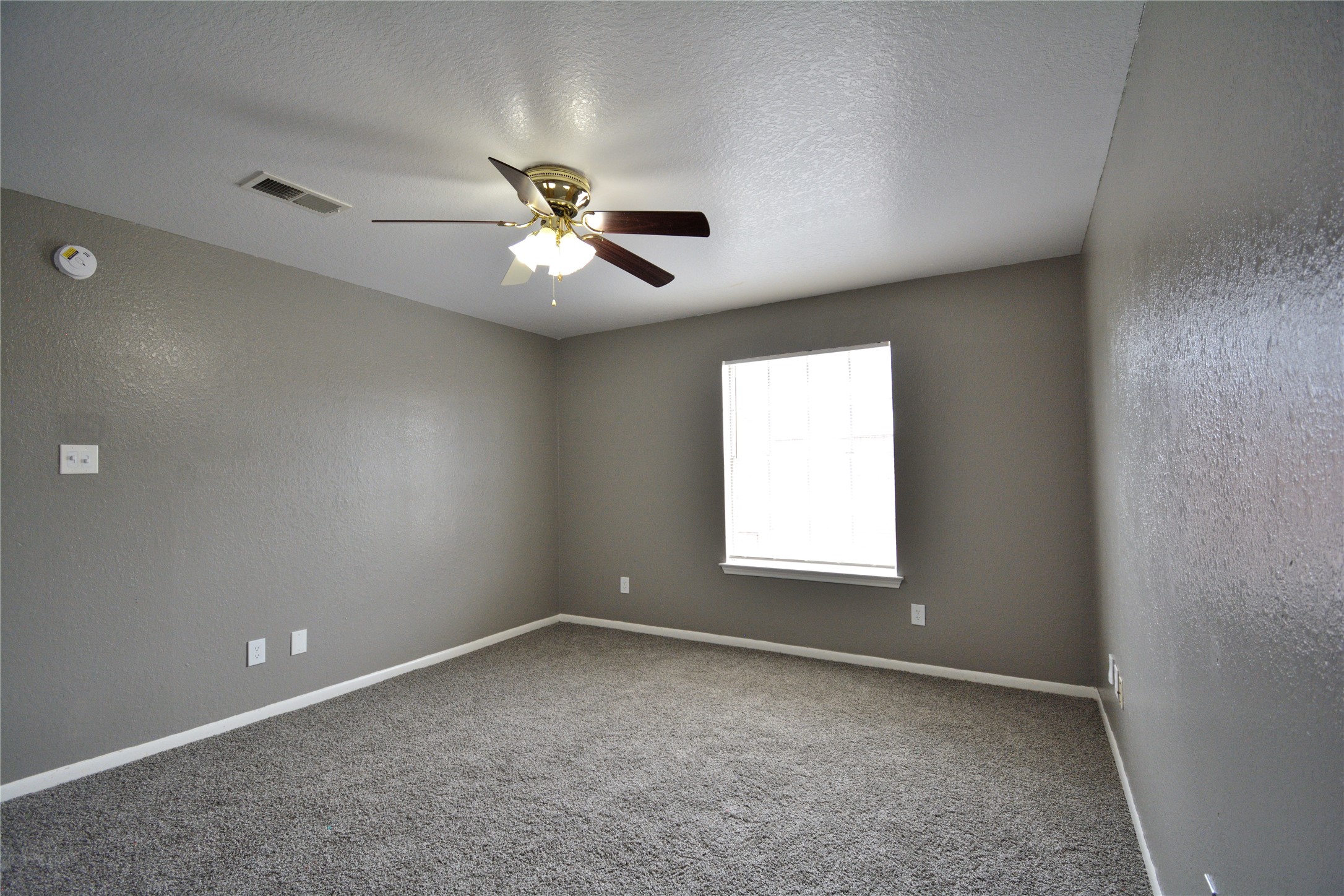 8904 Ledge Street Houston, TX 77075 - Photo 15 of 20 an empty room with a window and a fan