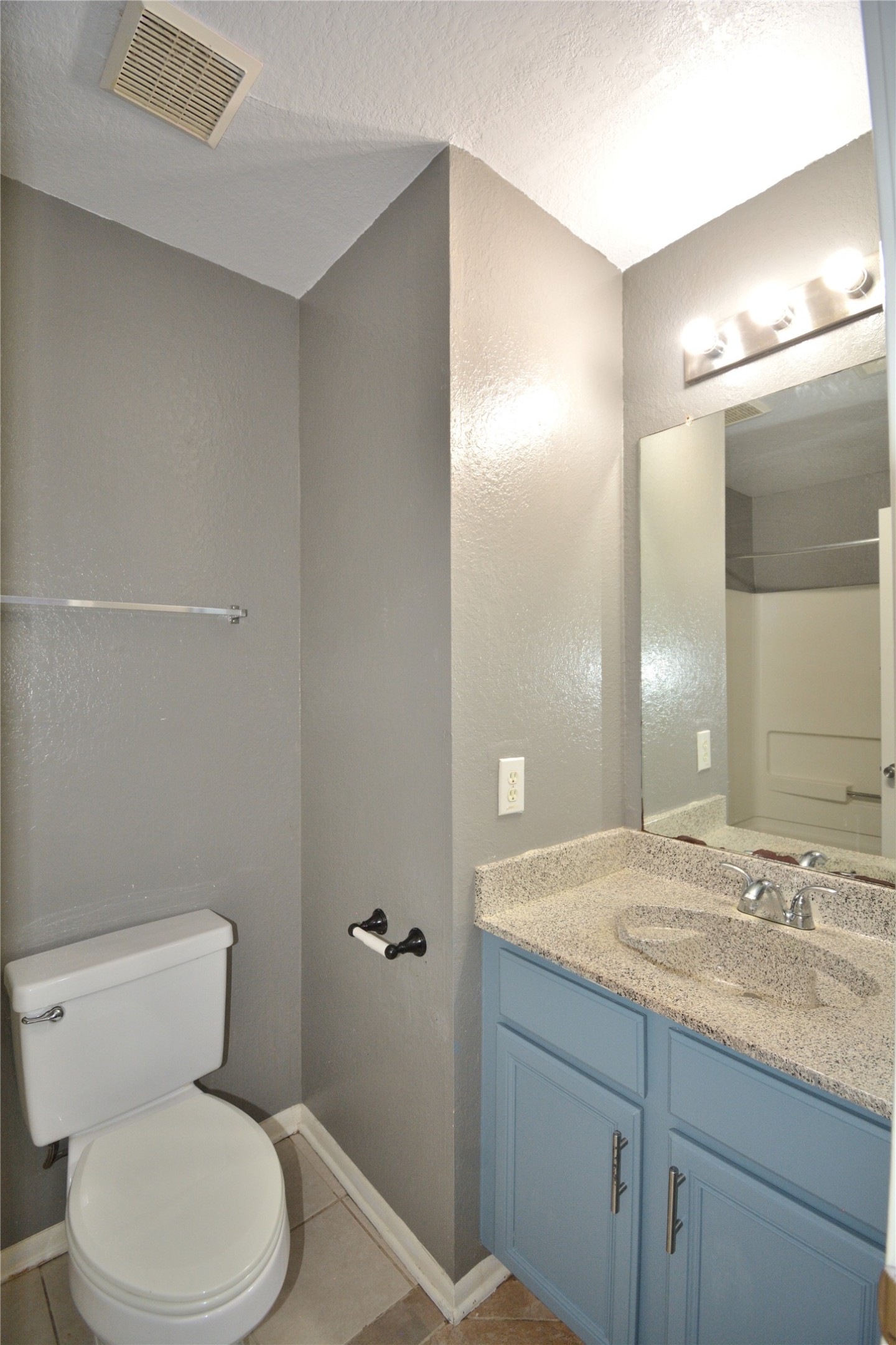 8904 Ledge Street Houston, TX 77075 - Photo 18 of 20 a bathroom with a granite countertop sink mirror vanity and toilet