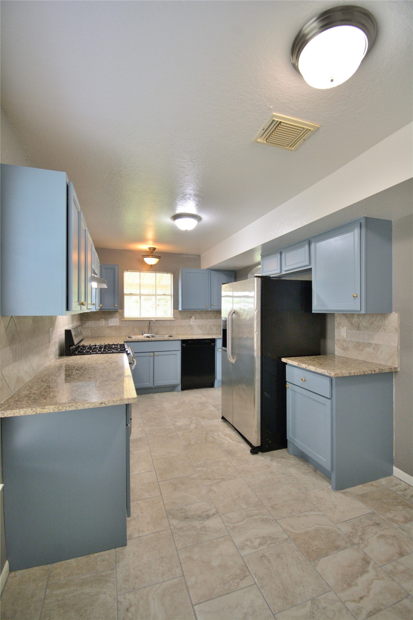8904 Ledge Street Houston, TX 77075 - Photo 10 of 20 a large kitchen with stainless steel appliances granite countertop a large counter top a stove a sink dishwasher and a refrigerator