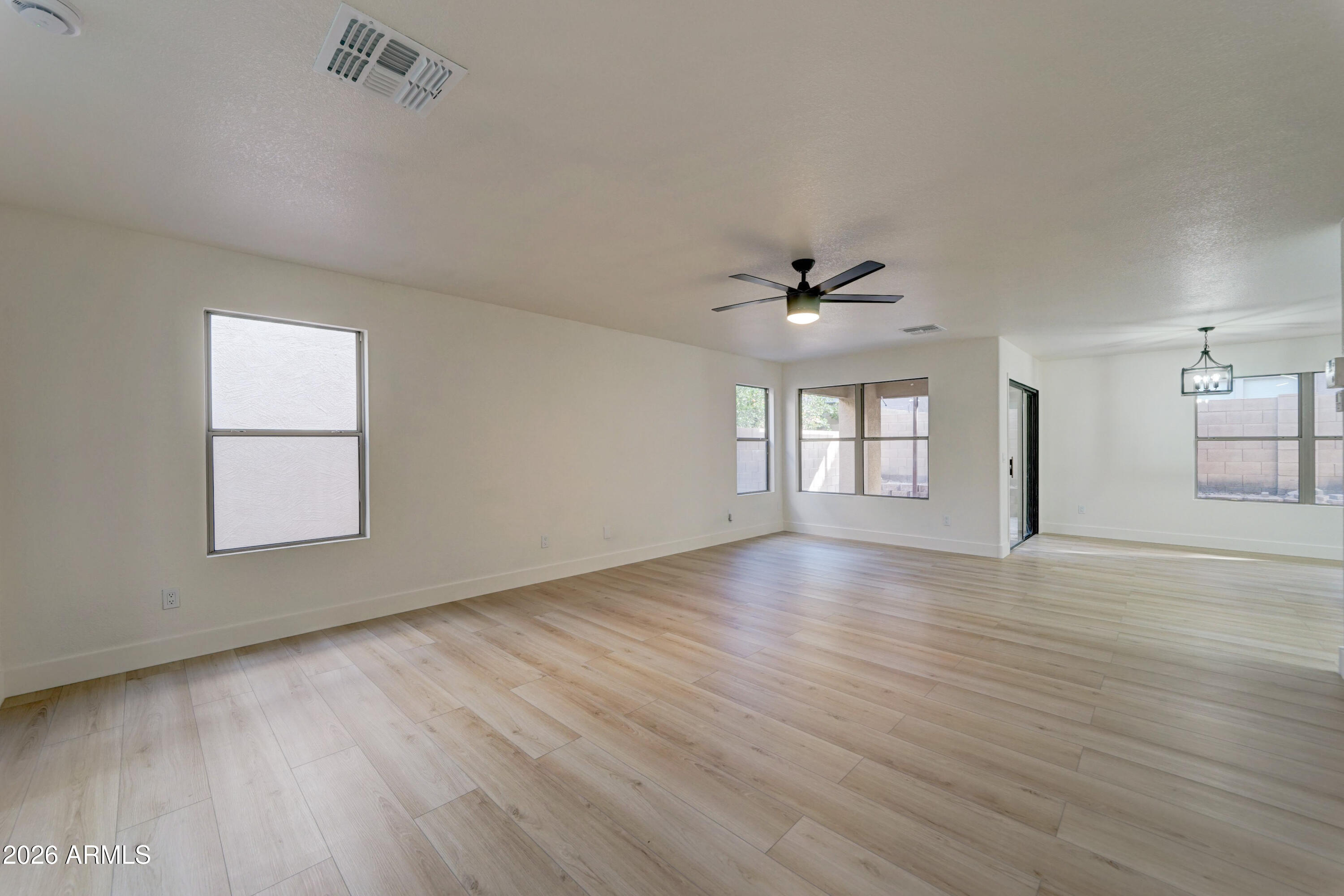 3491 South Chaparral Road Apache Junction, AZ 85119 - Photo 4 of 33 wooden floor in an empty room with a window