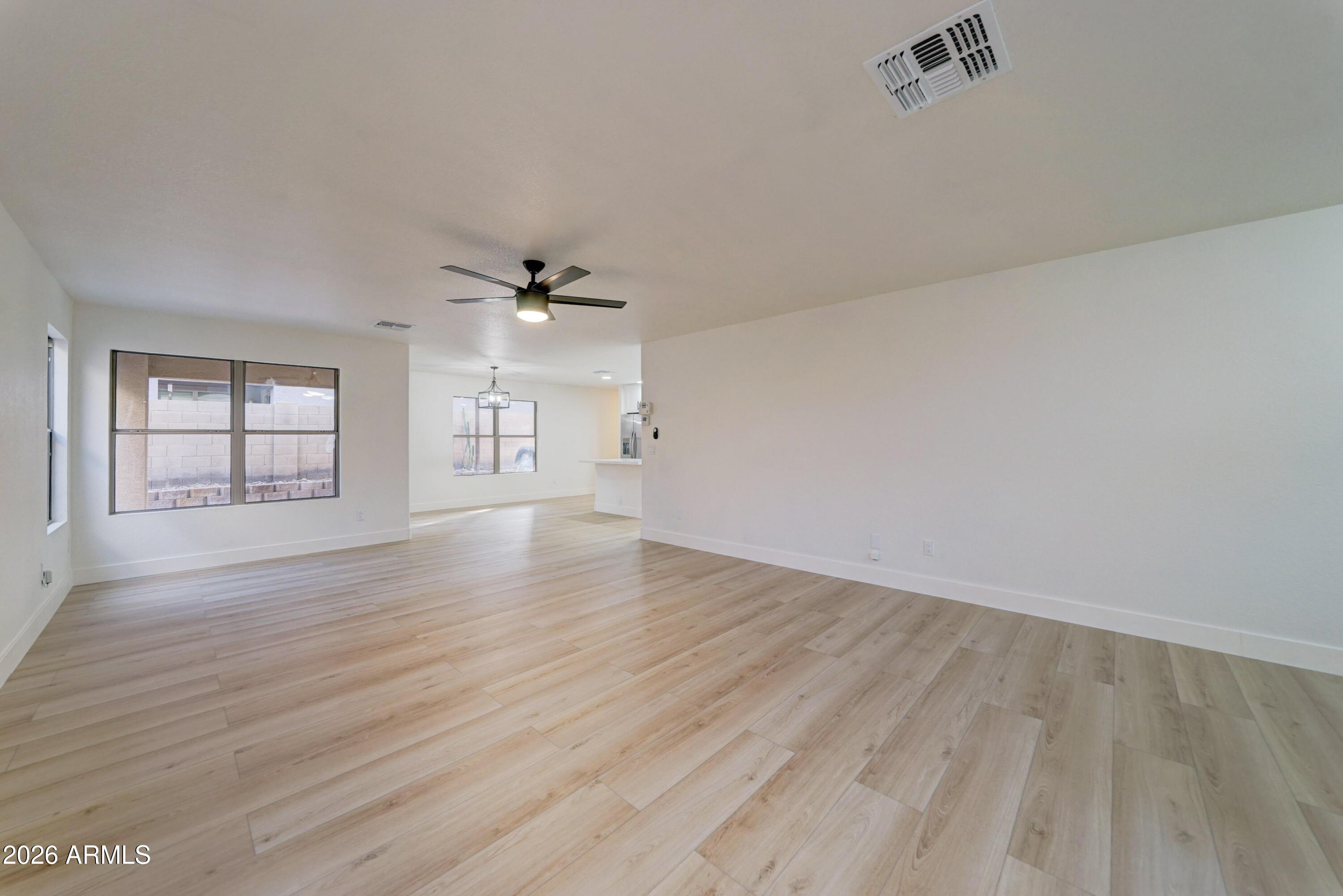 3491 South Chaparral Road Apache Junction, AZ 85119 - Photo 5 of 33 wooden floor in an empty room with a window