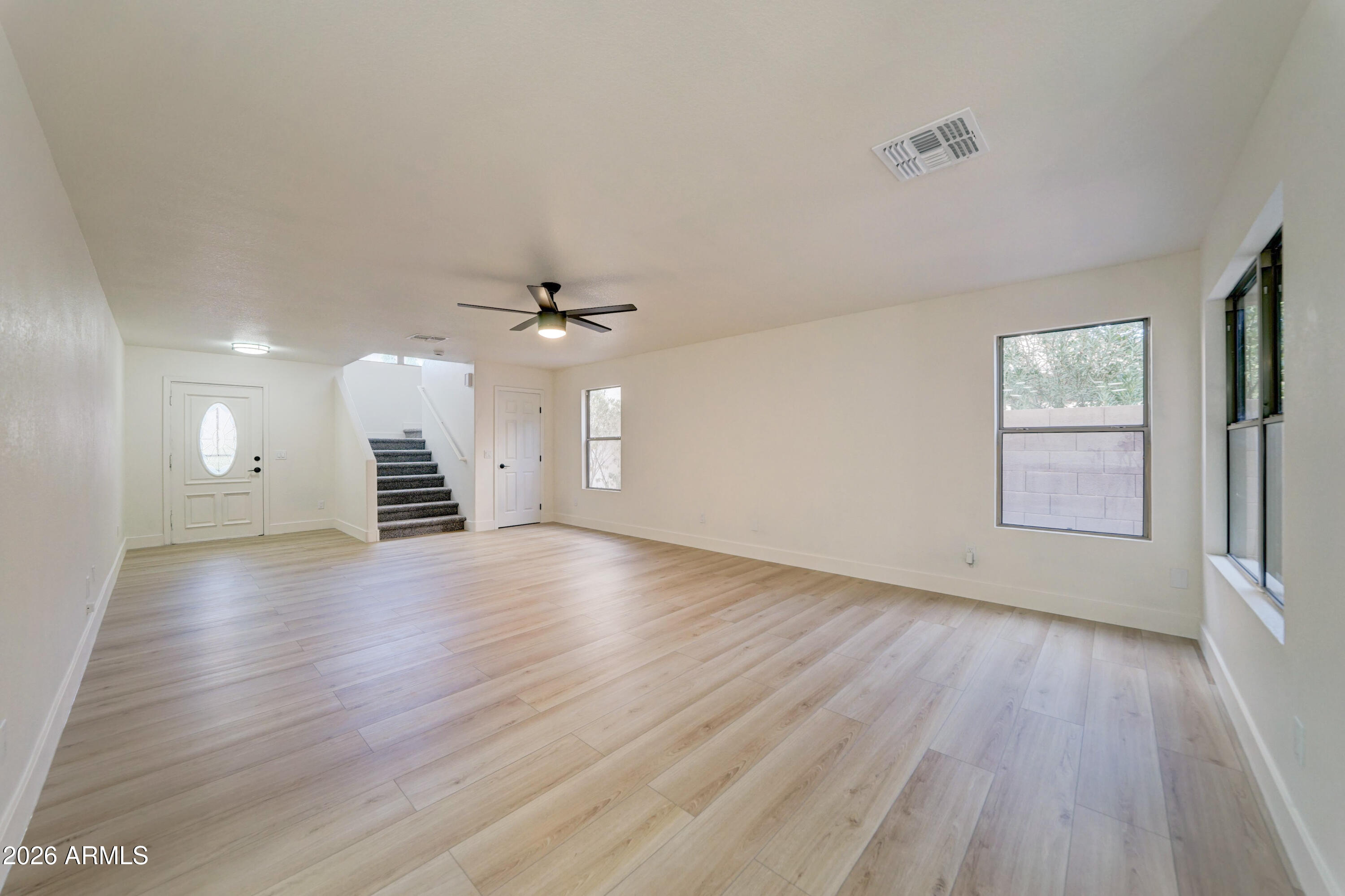 3491 South Chaparral Road Apache Junction, AZ 85119 - Photo 7 of 33 wooden floor in an empty room with a window