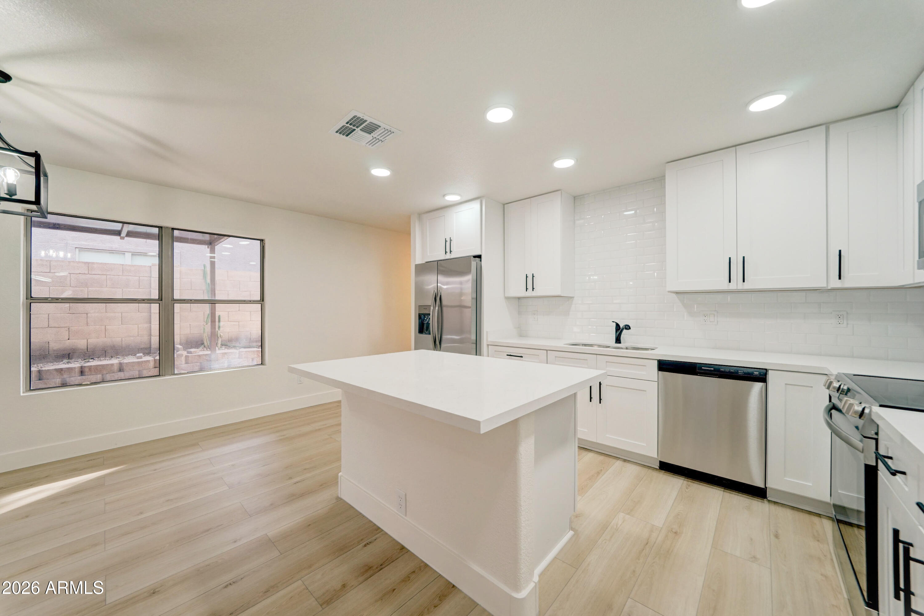 3491 South Chaparral Road Apache Junction, AZ 85119 - Photo 10 of 33 a kitchen with a sink stove and cabinets