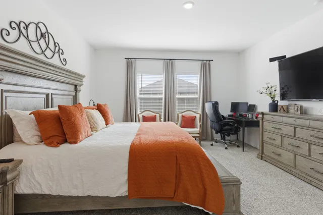 a bedroom with a bed and a flat screen tv