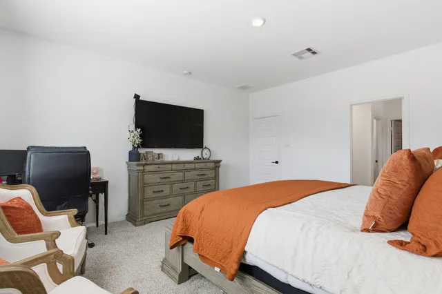 a en suite bathroom with a granite countertop sink and a mirror
