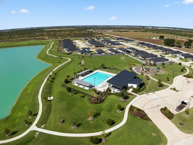 an aerial view of a house with swimming pool having outdoor seating
