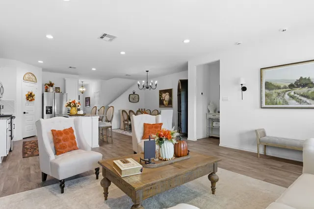 a living room with furniture a flat screen tv and a large window