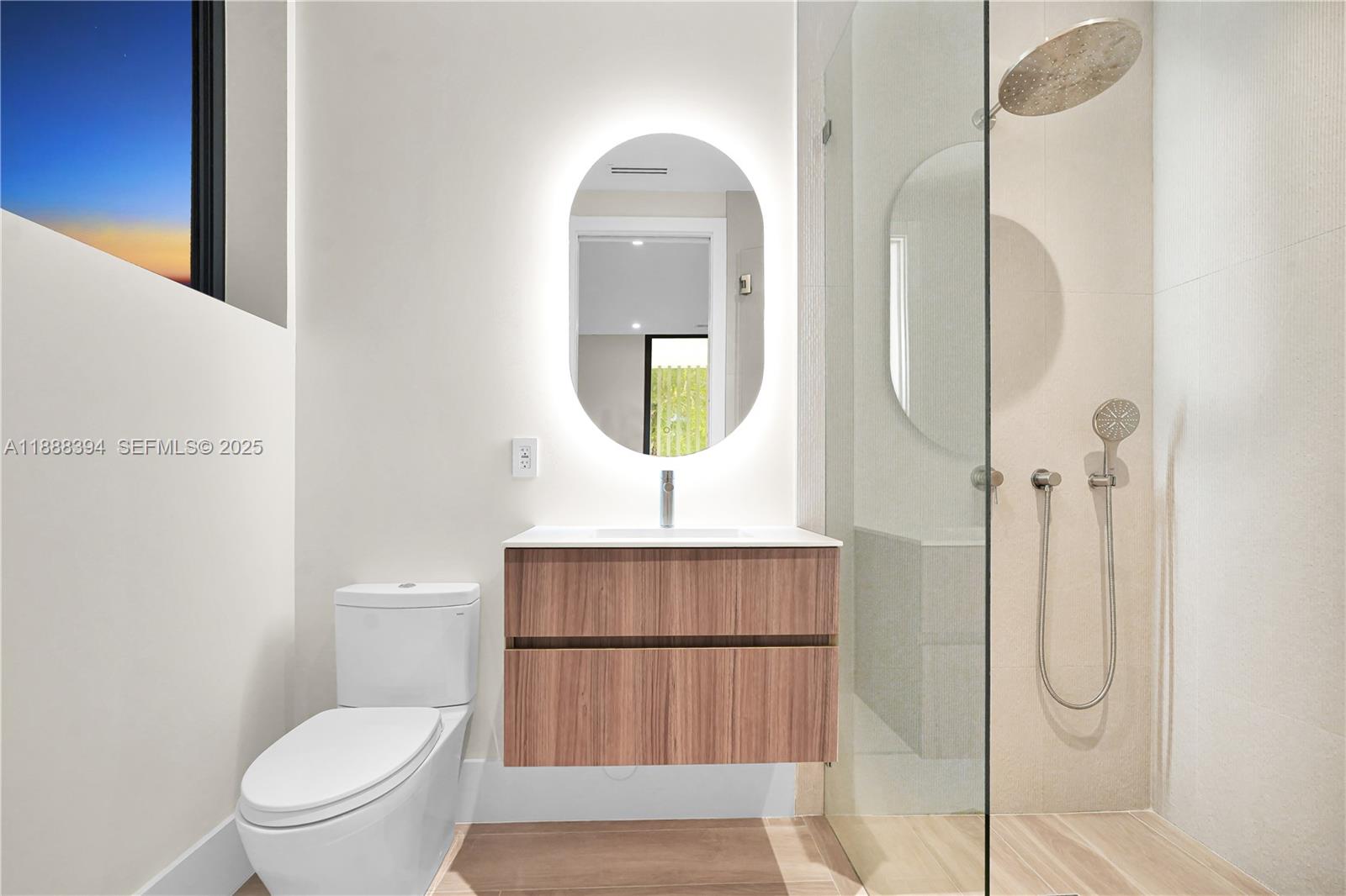 100 Hampton Lane Key Biscayne, FL 33149 - Photo 24 of 35 a bathroom with a toilet a sink and mirror