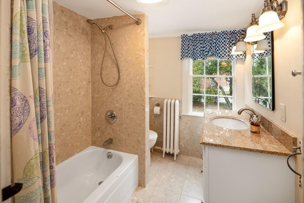 347 Main Street Hingham, MA 02043 - Photo 25 of 34 a bathroom with a granite countertop sink and a bathtub