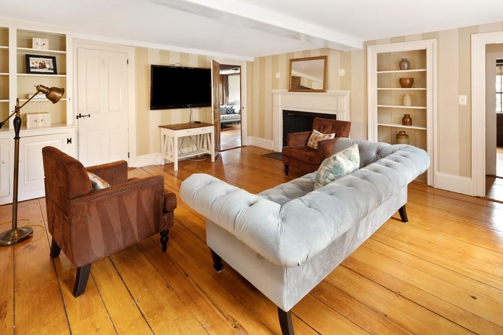 347 Main Street Hingham, MA 02043 - Photo 6 of 34 a living room with furniture a flat screen tv and a fireplace