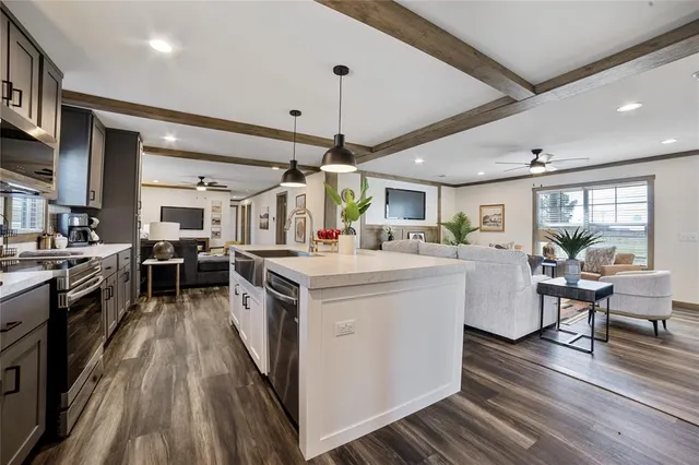 a kitchen with stove and wooden floor