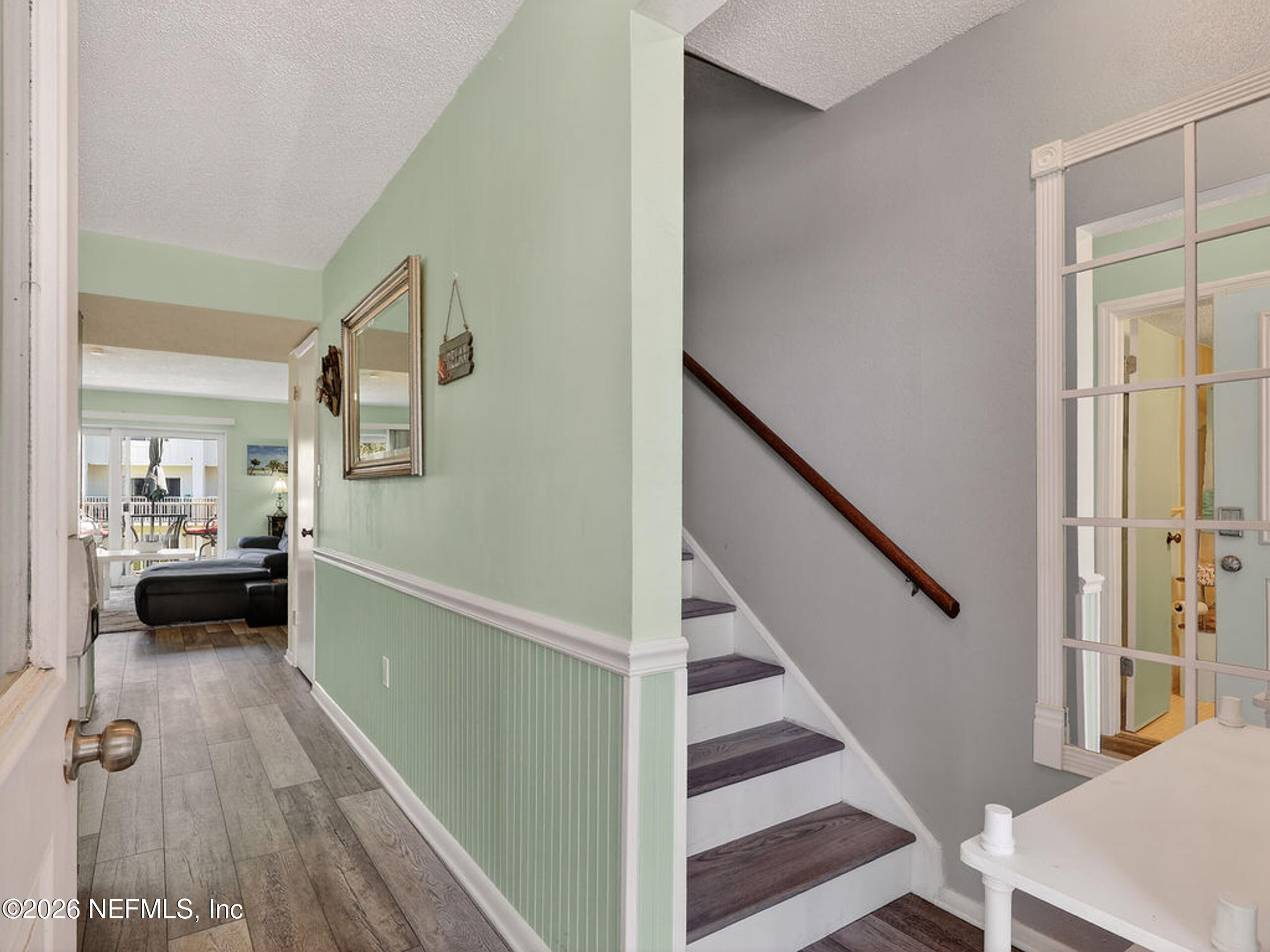 1 Ocean Trace Road, Unit 230 St. Augustine Beach, FL 32080 - Photo 19 of 50 a view of a hallway view with wooden floor and furniture