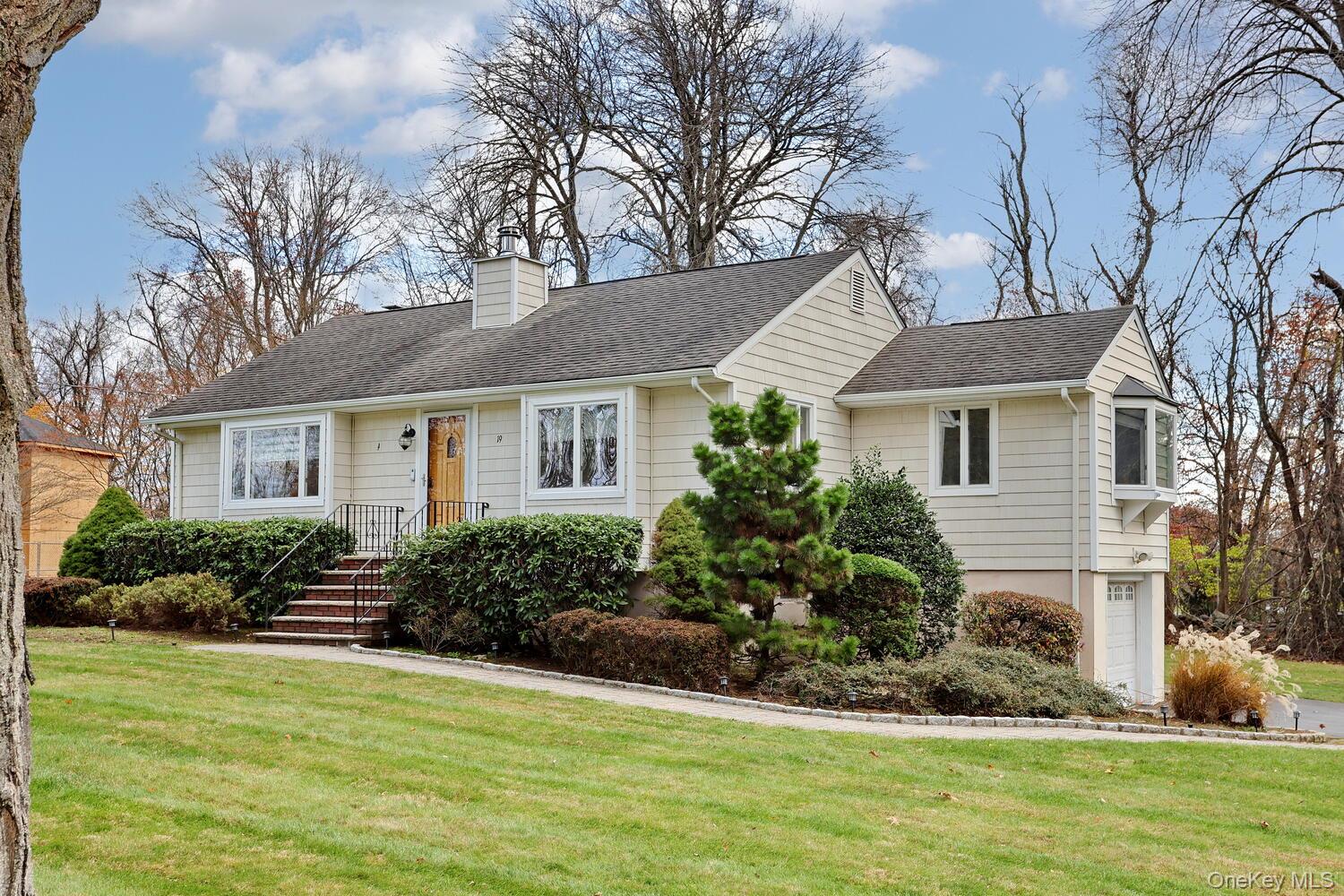 a front view of a house with a garden