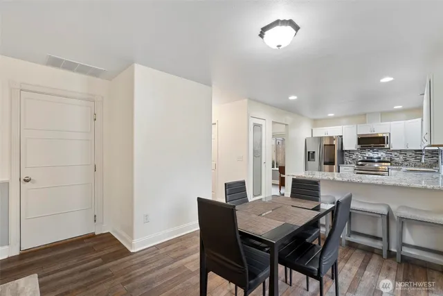 a view of a dining room with furniture and wooden floor