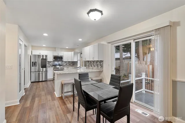 a kitchen with a table and chairs in it