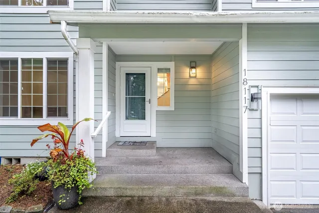 a front view of a house with outdoor seating and a potted plant