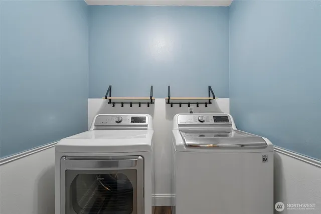 a view of storage and utility room with washer and dryer