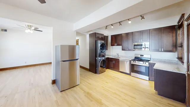 a kitchen with stainless steel appliances a refrigerator and a stove top oven