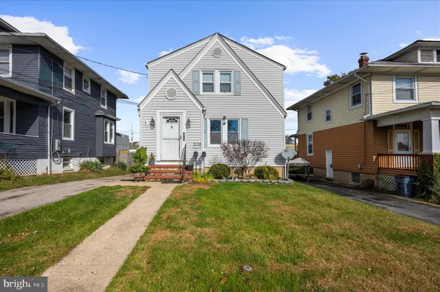 a front view of a house with a garden and plants