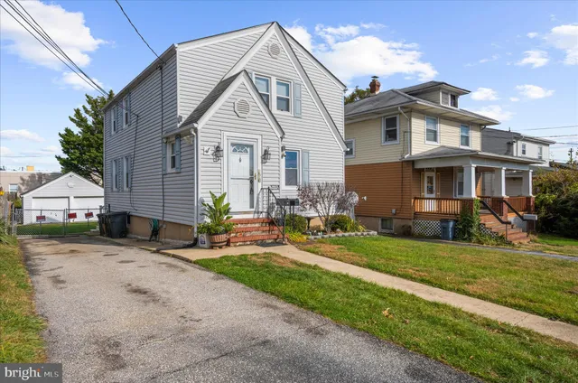 a view of a house with a yard and sitting area