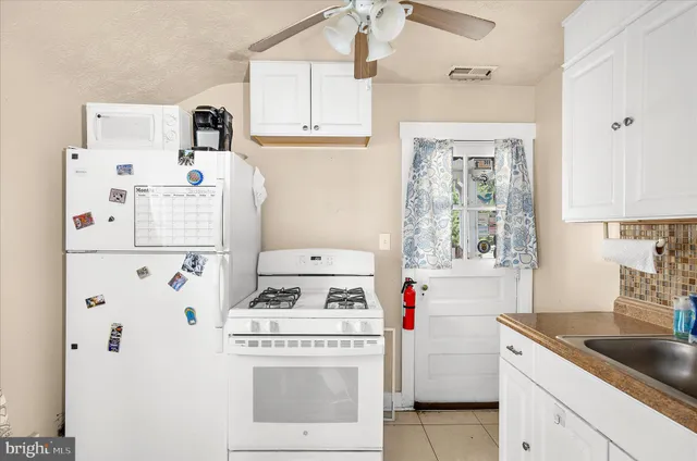 a kitchen with a stove a refrigerator and a sink