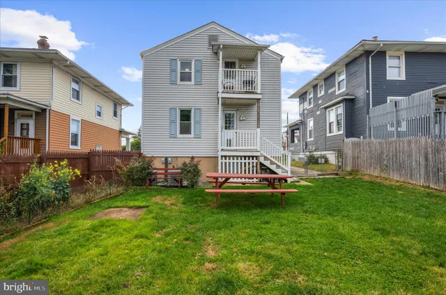 a view of a house with a yard and sitting area