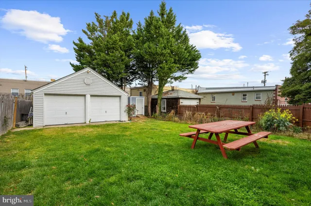 a front view of a house with a garden and outdoor seating