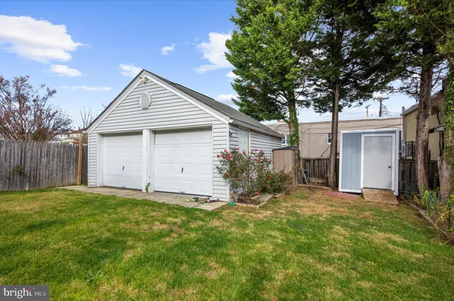 a view of a house with a yard and large tree