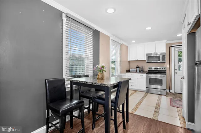 a view of a dining room with furniture and wooden floor