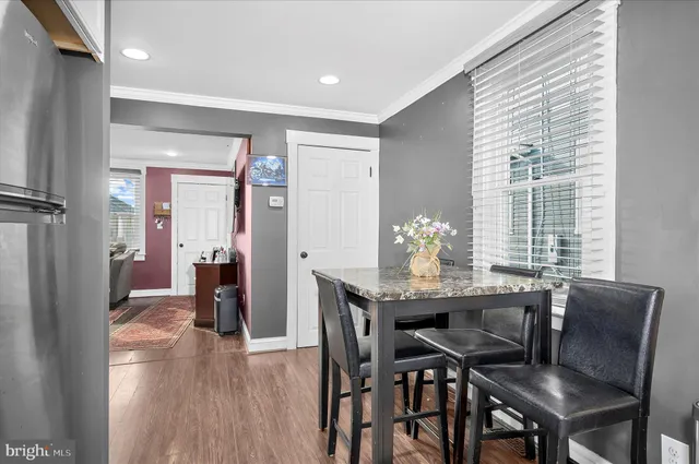 a dining room with furniture and wooden floor