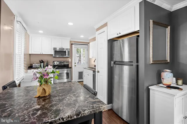 a kitchen with refrigerator and a sink