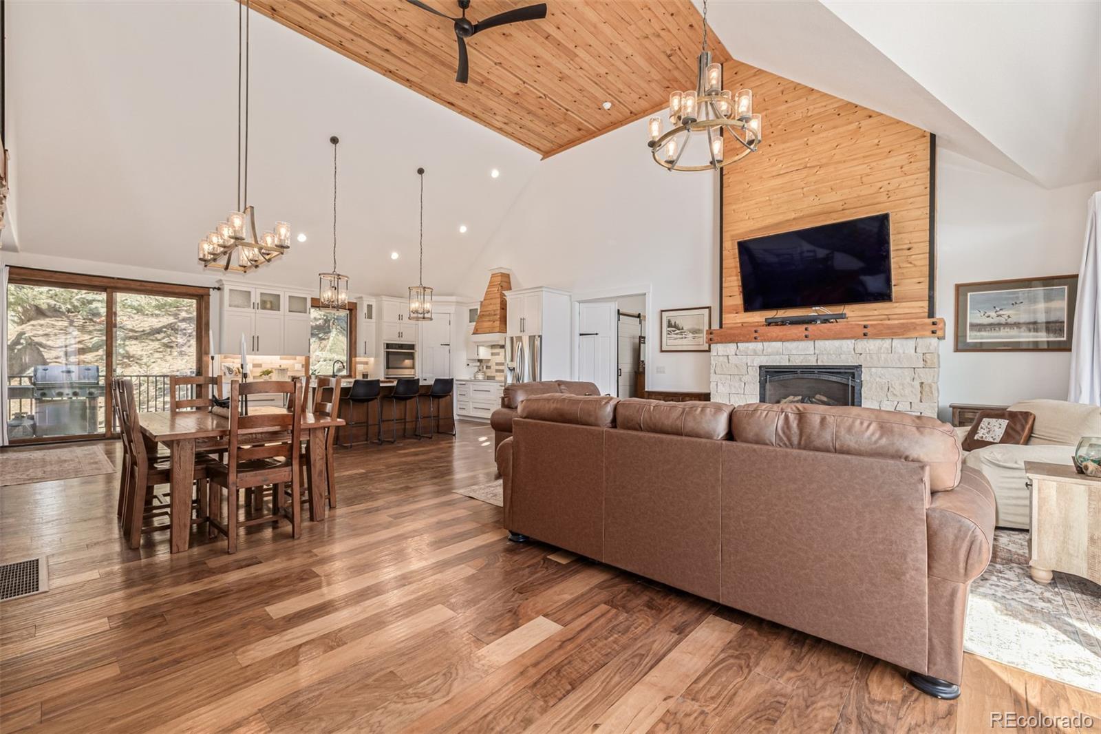 663 Brookside Drive Bailey, CO 80421 - Photo 6 of 47 a living room with furniture a flat screen tv and kitchen view