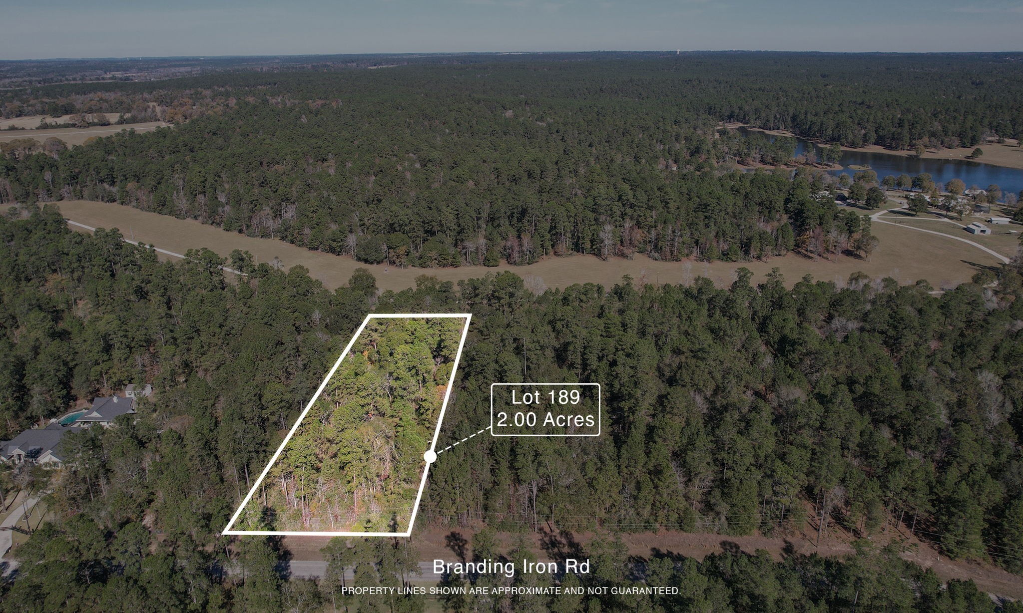 Lot 189 Branding Iron Road Huntsville, TX 77340 - Photo 3 of 48 a view of a city with lush green forest
