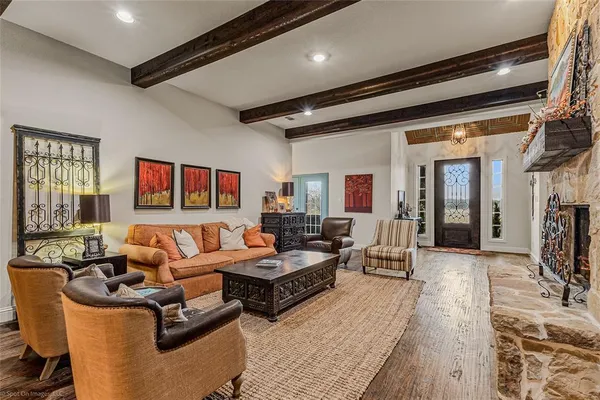 a living room with furniture wooden floor and a fireplace